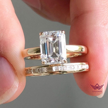 Load image into Gallery viewer, Medium Emerald Cut Hidden Halo Basket Tension Band D Color Two-Piece Moissanite Bridal Set